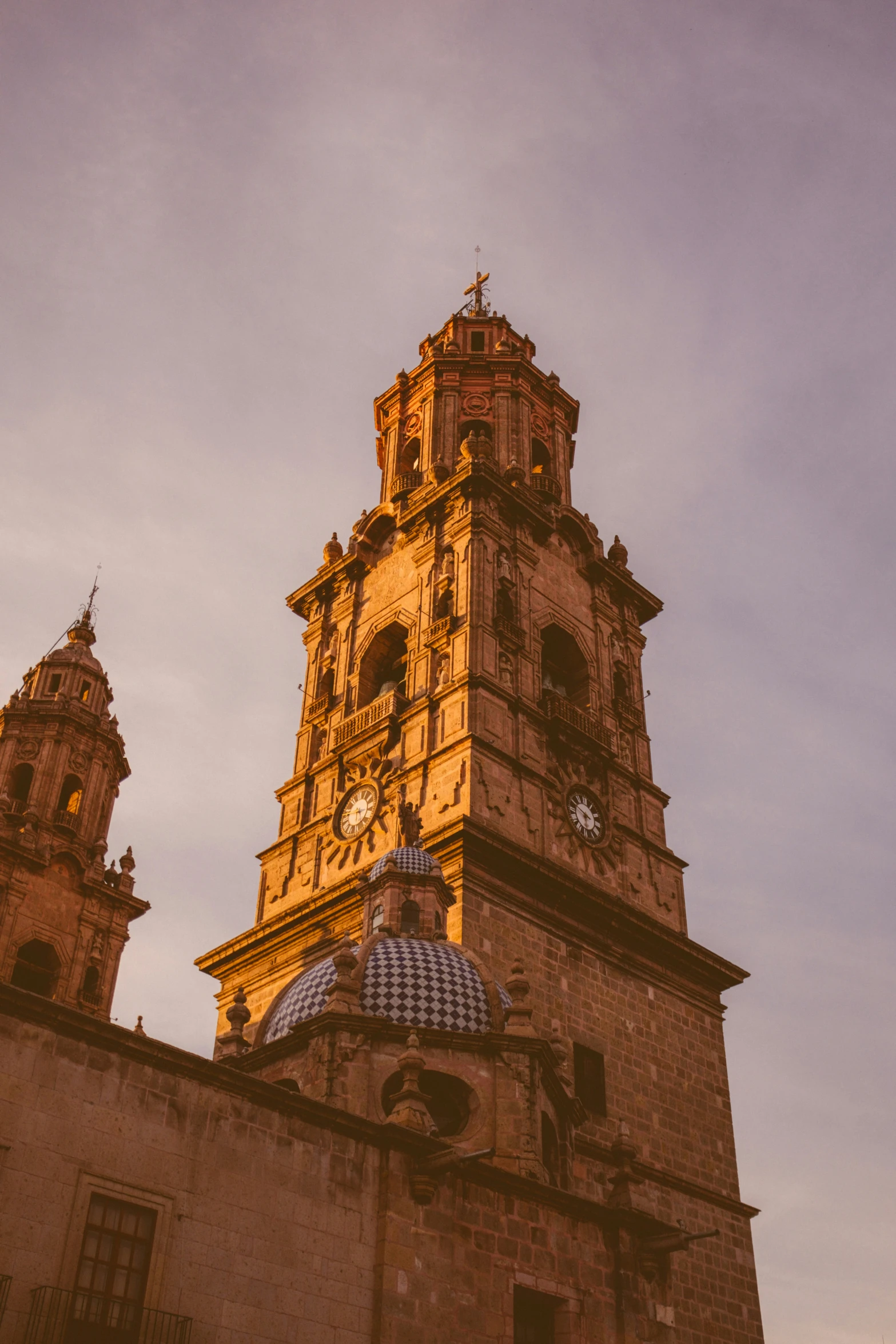 an intricate clock tower with sky behind it