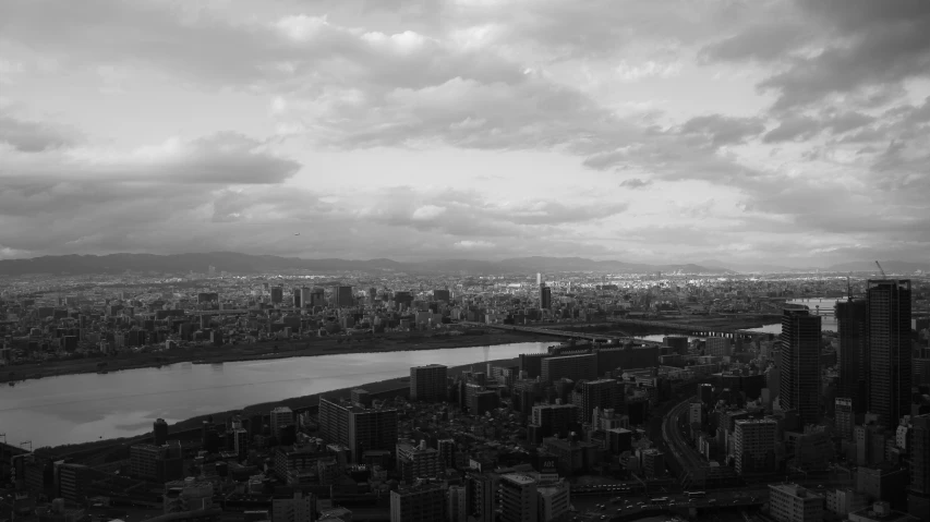 a large city with tall buildings and lots of clouds