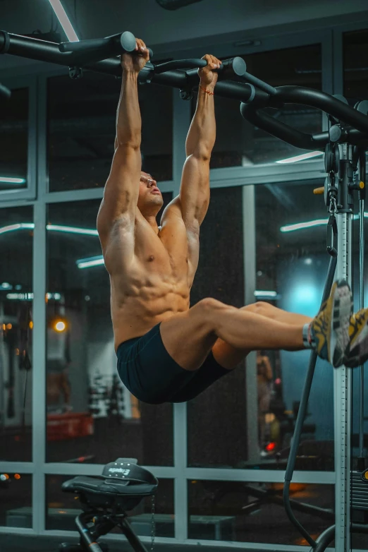 a man performing pull ups on a exercise machine