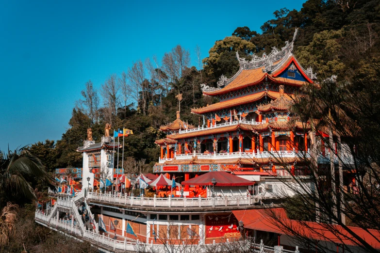 an oriental building has several stories and red roofs