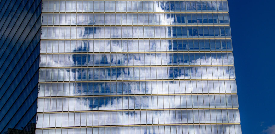 the side of an office building reflected in it