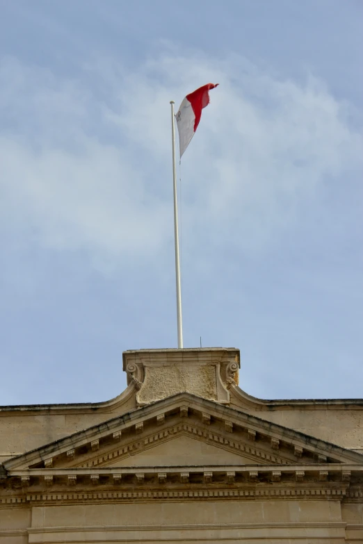 a flag pole is seen on top of an old building