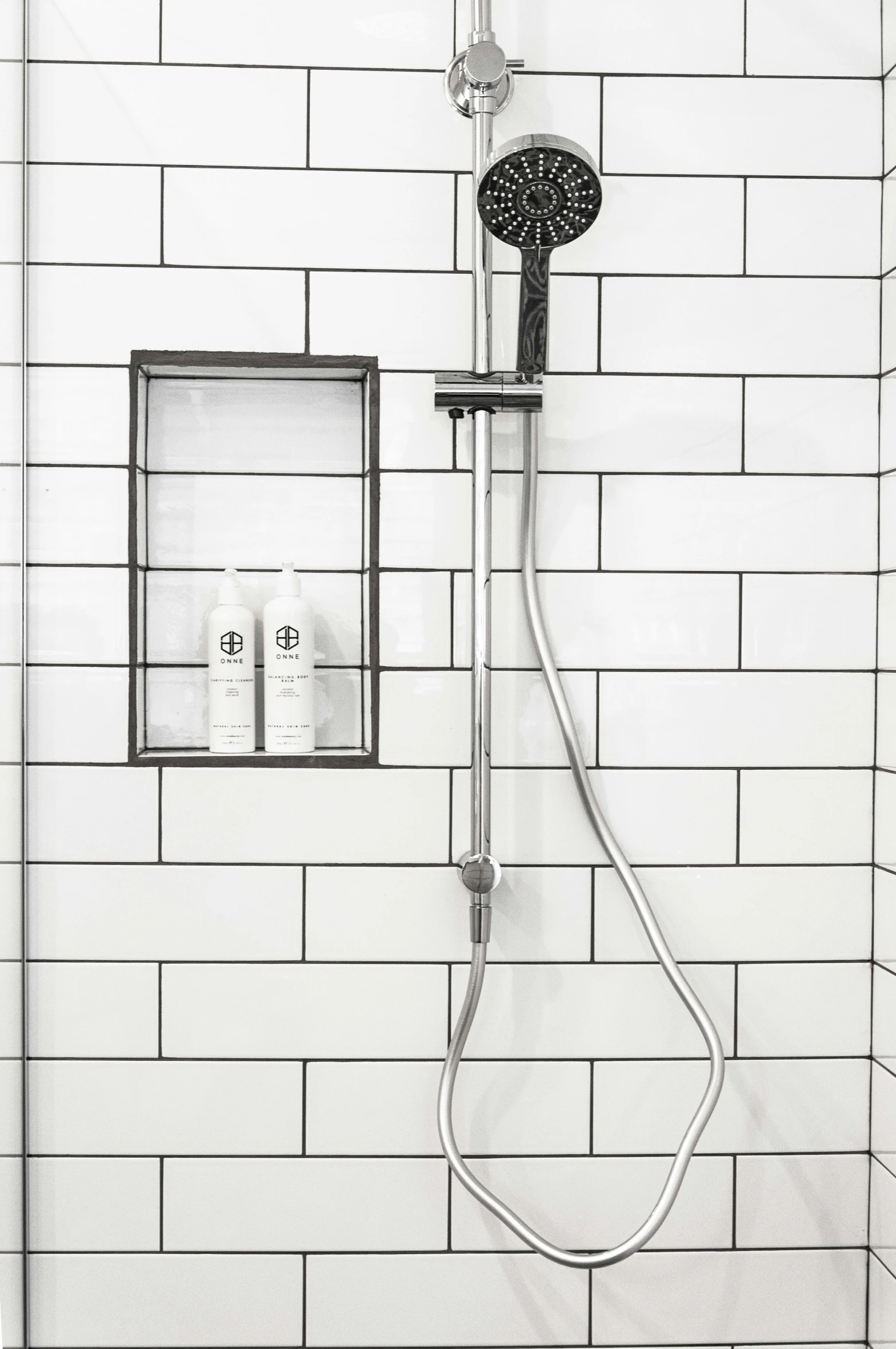 a shower head in the shower with the handle extended