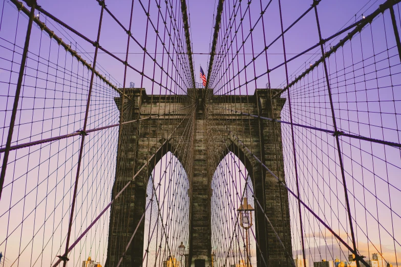 an image of a bridge at sunset with ropes