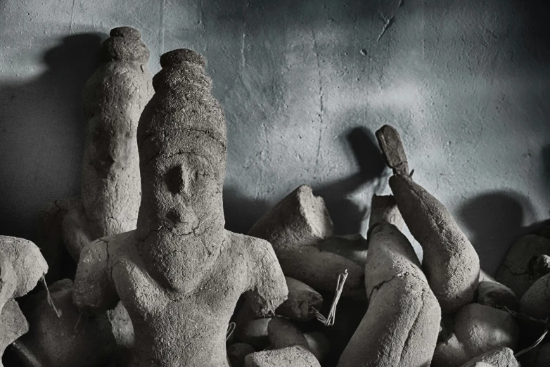 stone sculptures displayed against a wall in a display