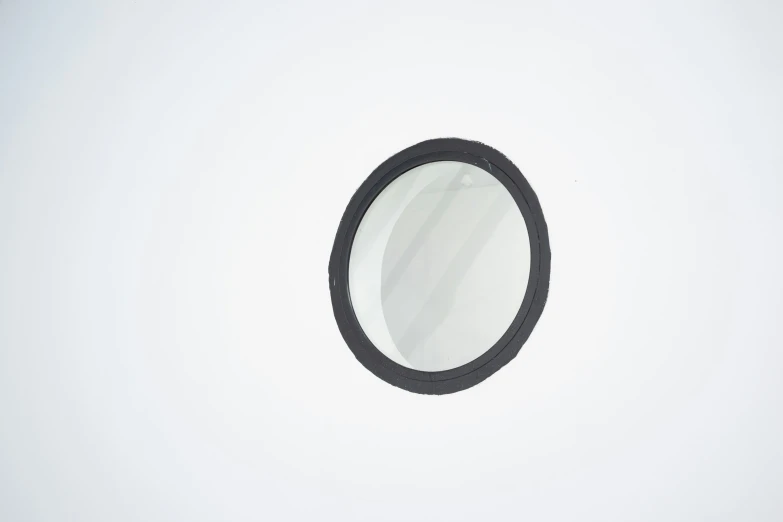 a close up of a mirror with black rings