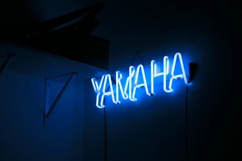 a black wall with neon lights and blue signs