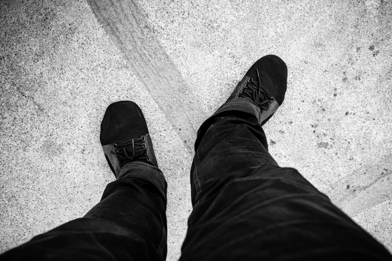 a person with feet crossed wearing a pair of jeans