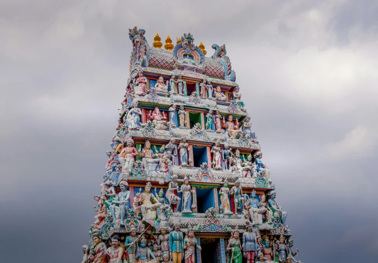 a multi colored tower with statues on it