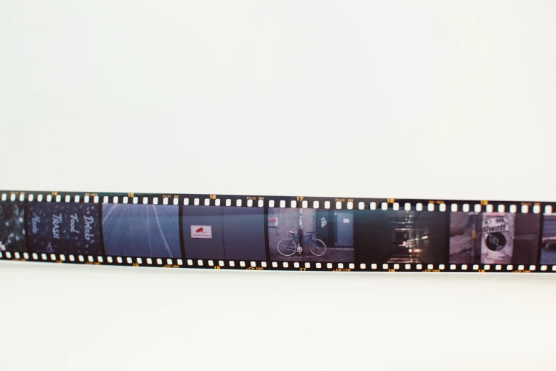 film strip with multiple pographs on it and one has a camera lens