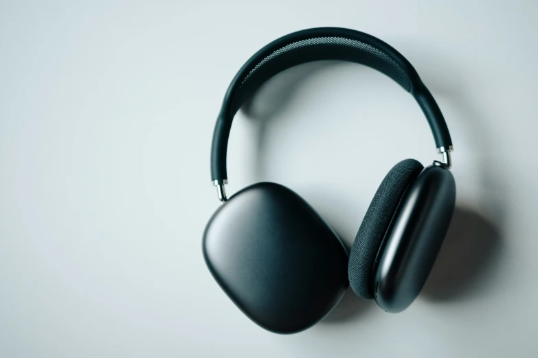 black headset sitting against a white wall