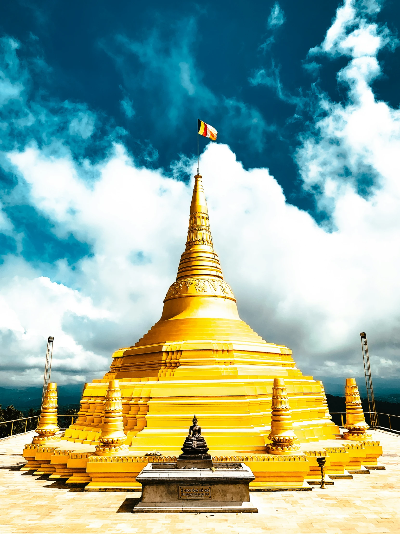 the yellow pagoda stands out against a blue sky