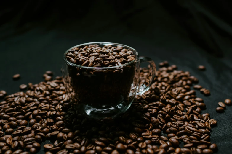 a glass cup filled with coffee beans