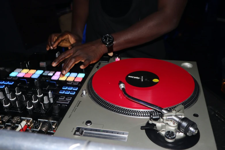 a dj using the decks to record a track