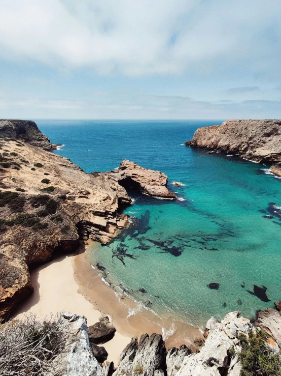 a beautiful sandy beach and clear blue waters in front of the ocean