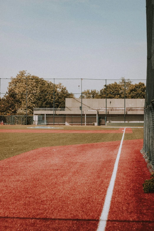 the baseball field is empty of players and the dirt