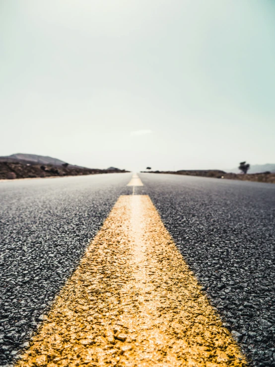 the yellow line on the road indicates the lanes that the car is driving