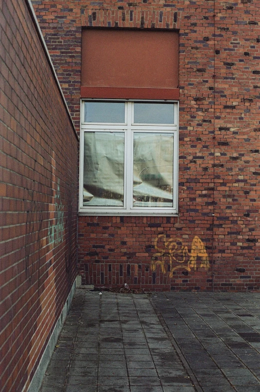 a red brick wall in front of a white window