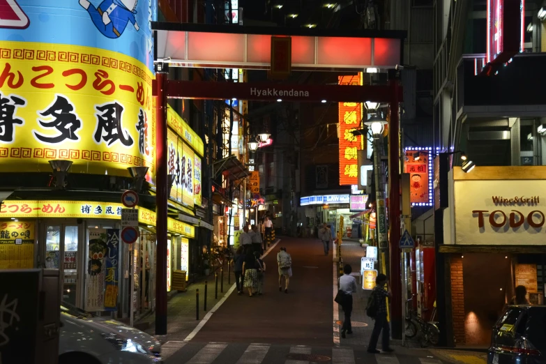 a busy asian street with a lot of buildings and signs