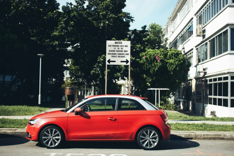 a red car in the street near some buildings