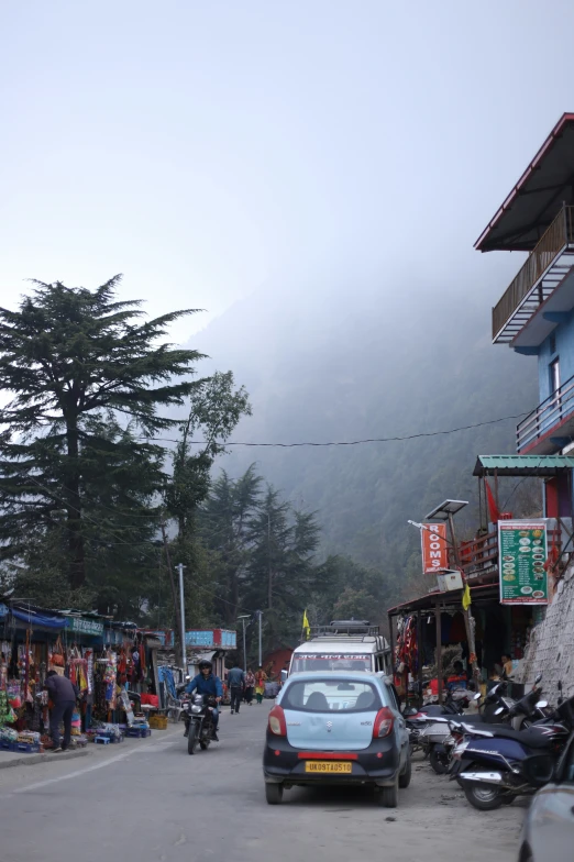 a street filled with lots of traffic next to tall buildings