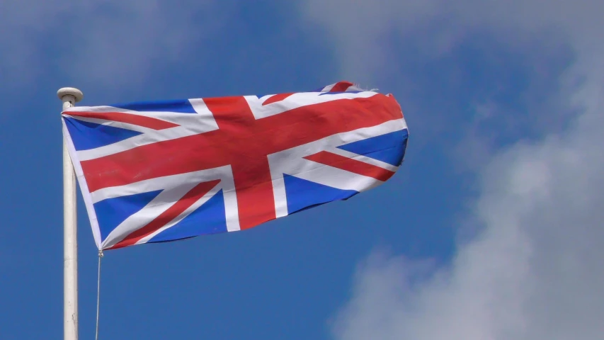 a red white and blue flag on a flag pole