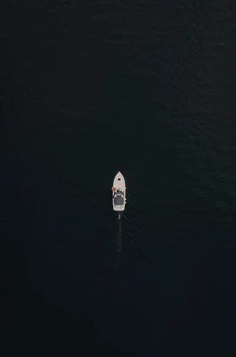 the small boat floats in the deep water