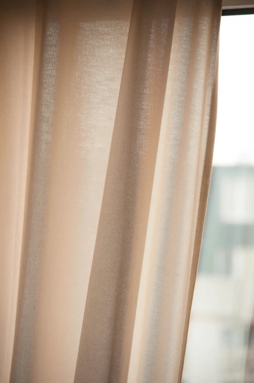 close up of the back of a curtains and some windowsill