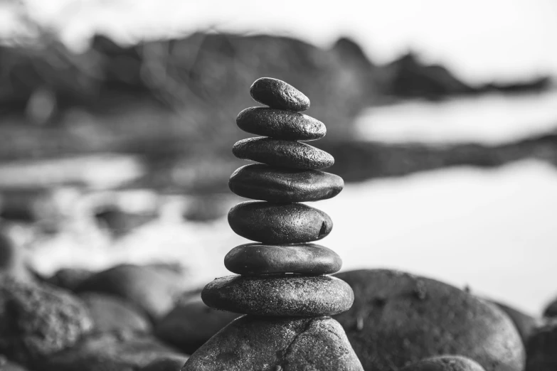 a stack of rocks sit together on some water