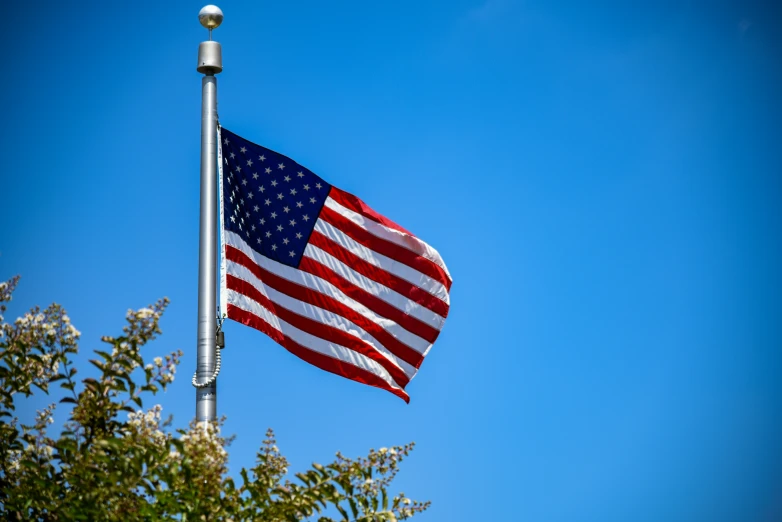 an american flag flies high in the air