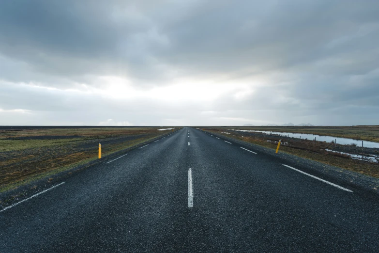 a road with no traffic on it during a cloudy day