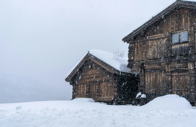 an old building surrounded by snow and dust