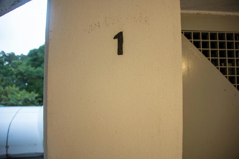 the door is made out of cement with a number one on it