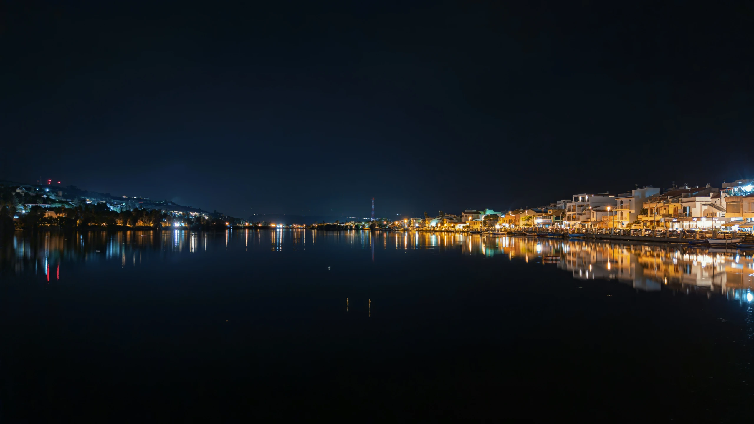 a city next to a body of water at night