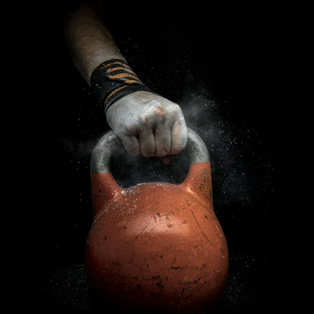 an orange kettle covered in white powder is thrown into the air