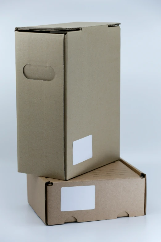 a cardboard box and a closed cardboard carton sitting on top of each other