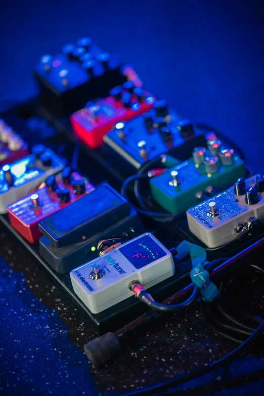 the four pedals are sitting on the electronic desk