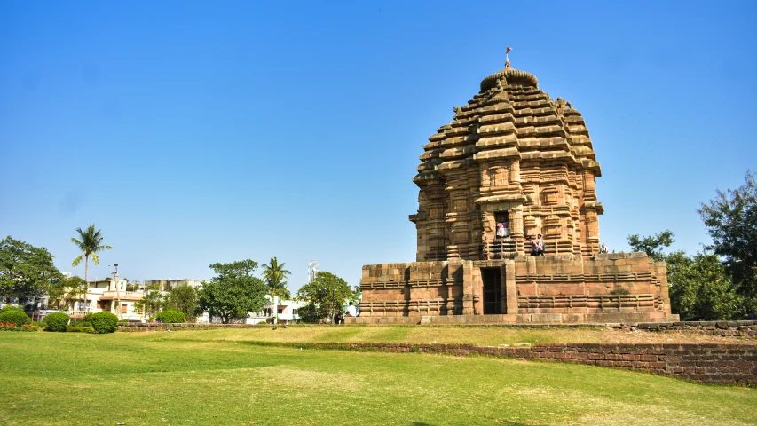 a large stone structure on a green field