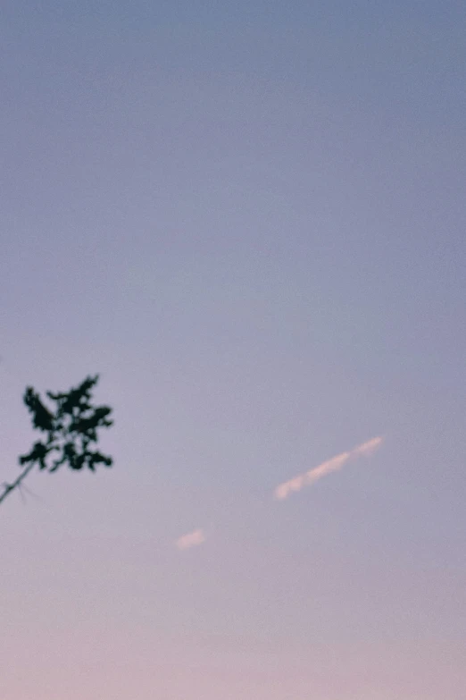 an airplane flying against the blue sky with clouds