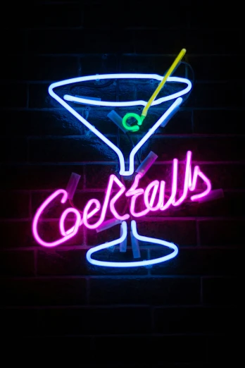 a neon sign advertising a cocktail