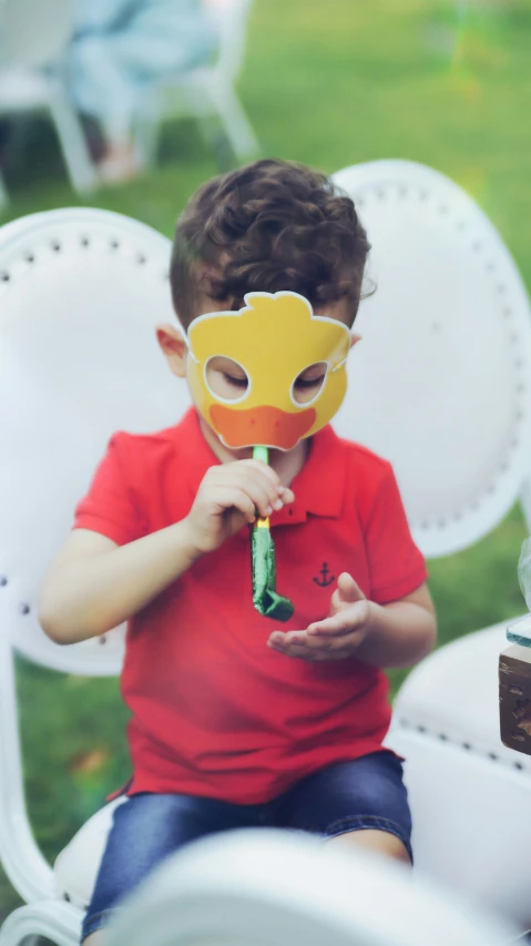  wearing mask and sitting in white chair