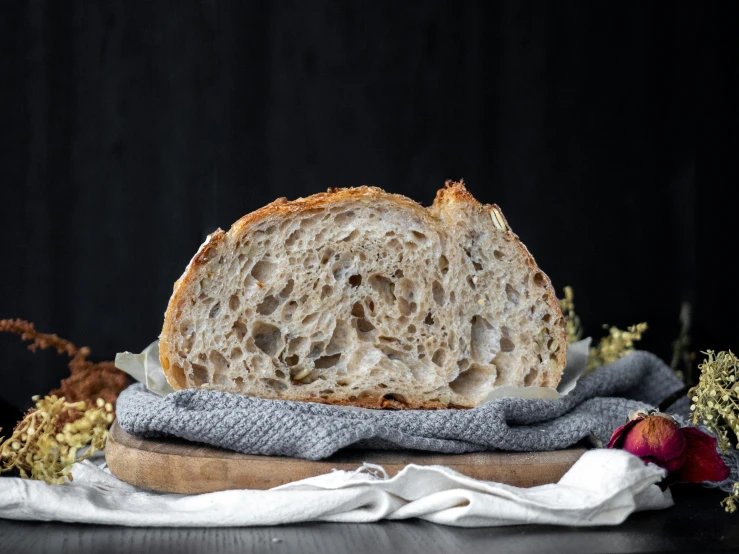 a half eaten bread on a wooden board