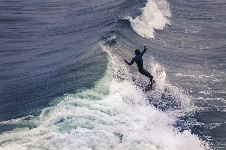 a man riding a wave on top of a surfboard