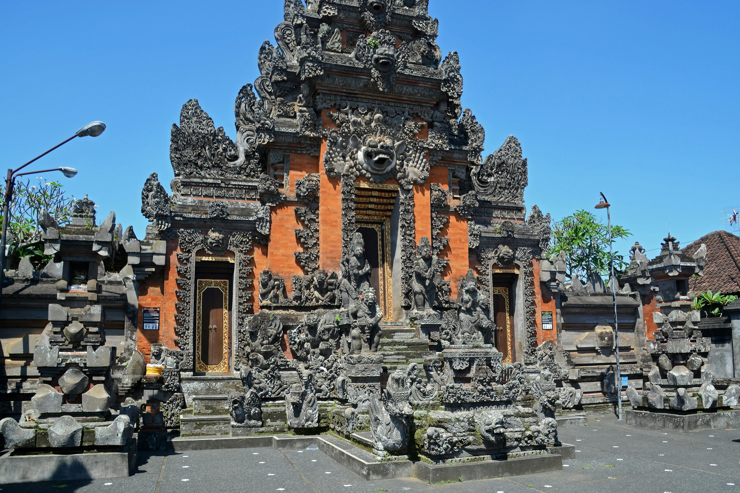 a large building surrounded by rocks on a sunny day