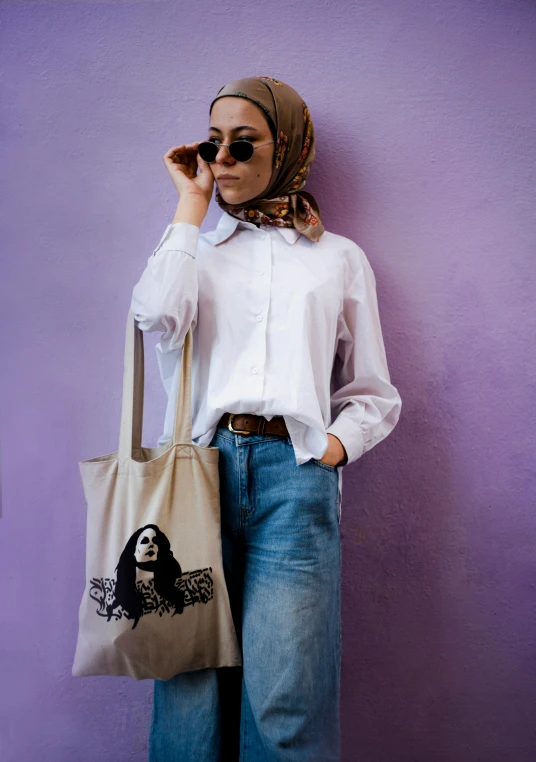 woman in white shirt holding up a brown bag