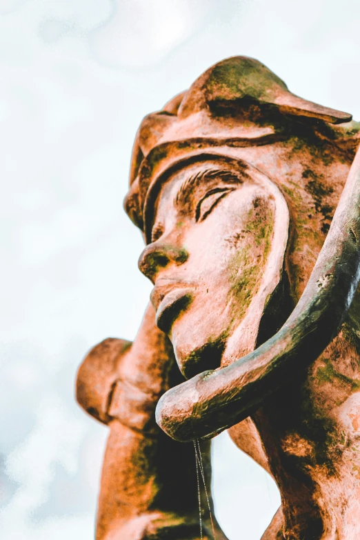 a bronze statue of a woman with an umbrella