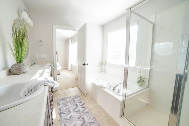 a white bathroom with a large tub and shower