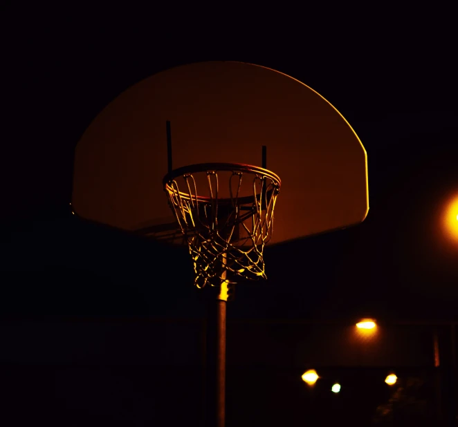 a basketball is in the basket at night