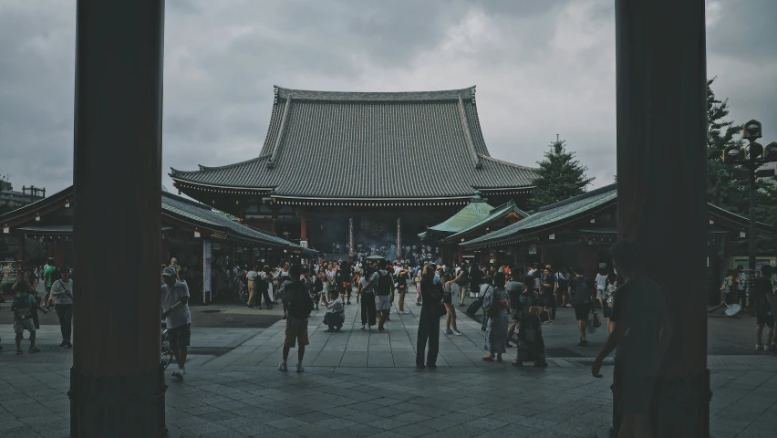 an outdoor area with a building and many people