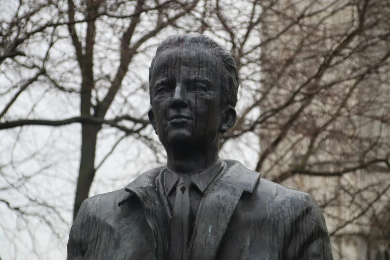 a statue of president ronald reagan, outside of a large building